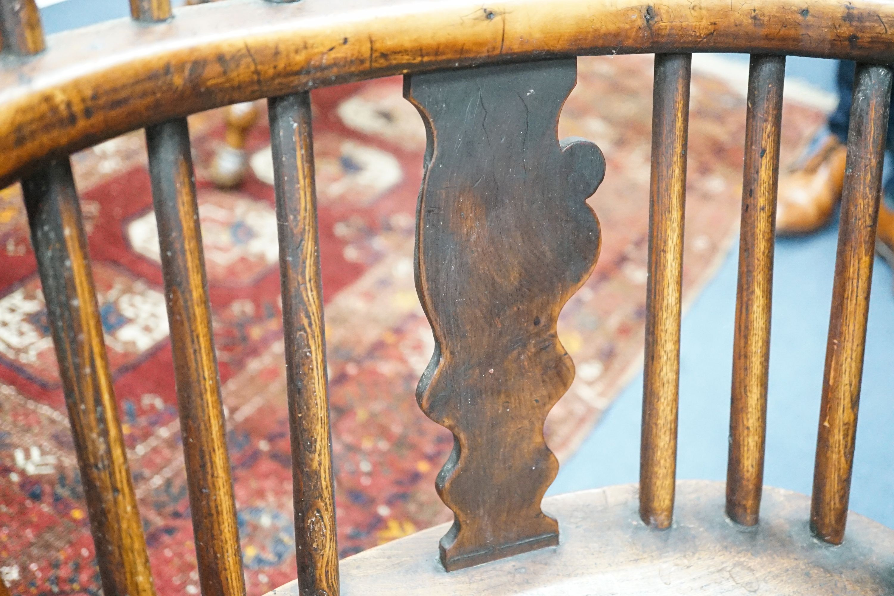 A 19th century yew and elm Windsor elbow chair with blind splat and crinoline stretcher, width 55cm, depth 40cm, height 93cm